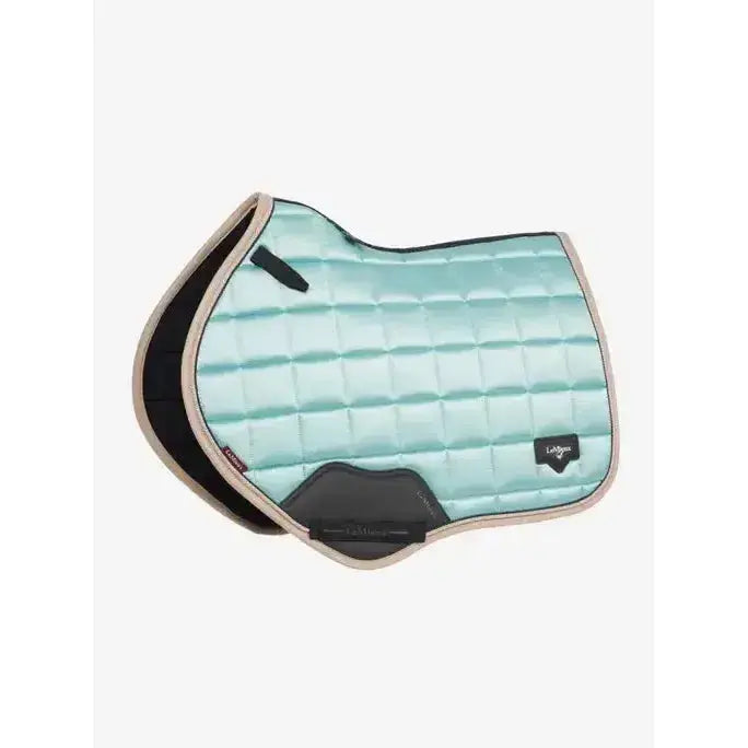A mint green quilted lemieux loire classic close contact saddle pad with black beige trim and lohman logo