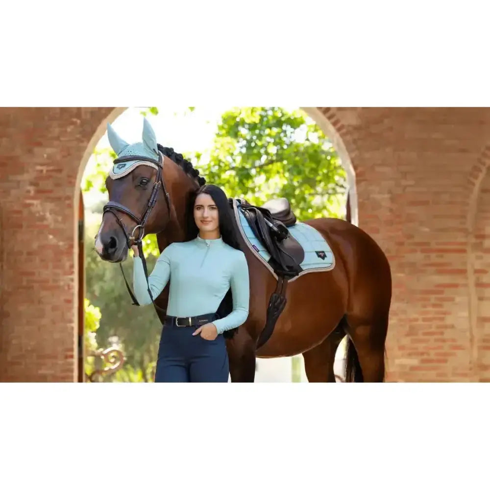 A light blue lemieux loire classic horse headpiece with subtle pattern and matching saddle pad for close contact riding