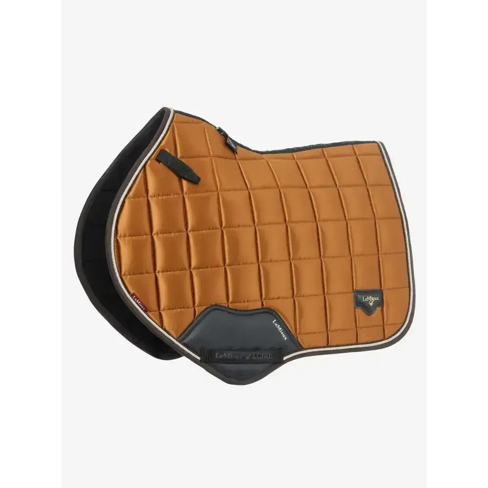 Tan quilted saddle pad with black trim and lemieux logo patch from lemieux loire classic collection