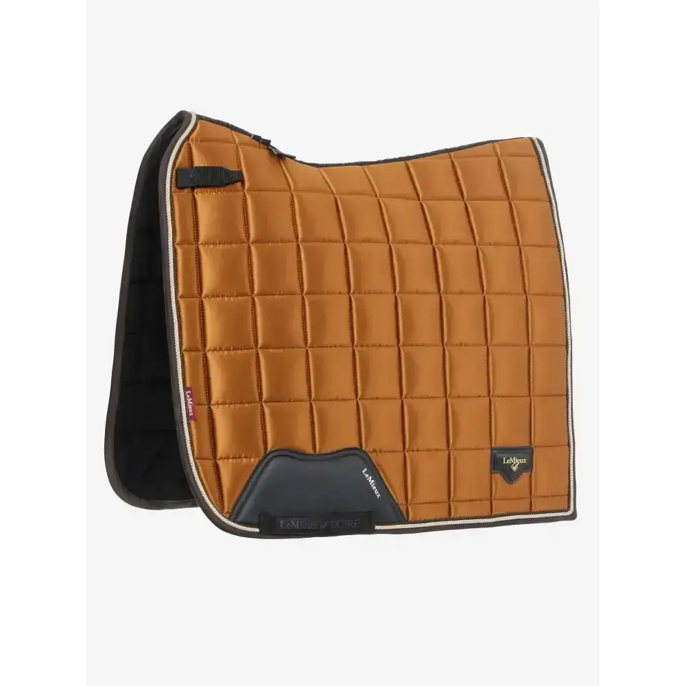 Tan quilted lemieux loire classic dressage square ginger saddle pad with black trim and branded logo patch