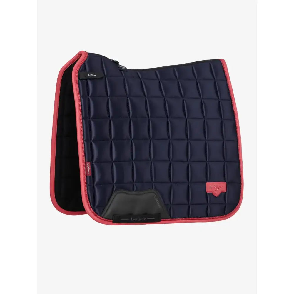 Navy blue quilted lemieux loire classic dressage square navy cranberry pad with pink trim and black footpad with logo patch