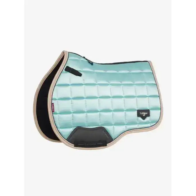 A mint green quilted lemieux loire classic gp square saddle pad with black and beige accents and sleek design