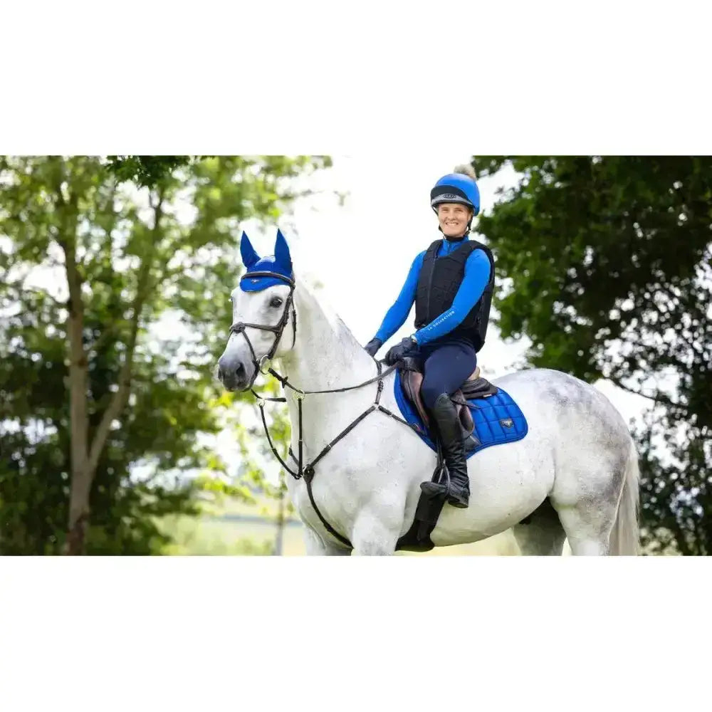 Blue lemieux loire close equestrian helmet with small pom pom on top for stylish safety in contact riding