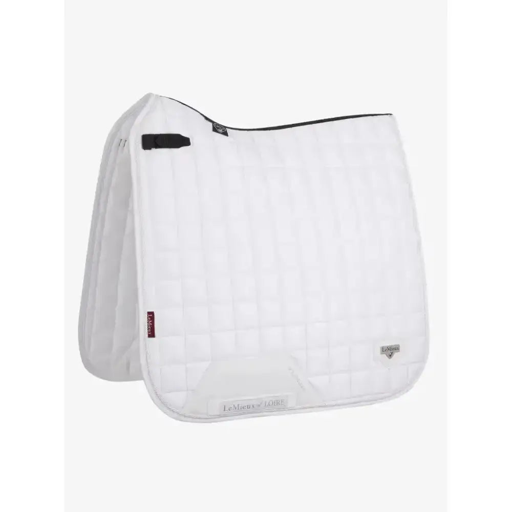 White quilted lemieux loire dressage square saddle pad with black trim and small logo for stylish dressage use