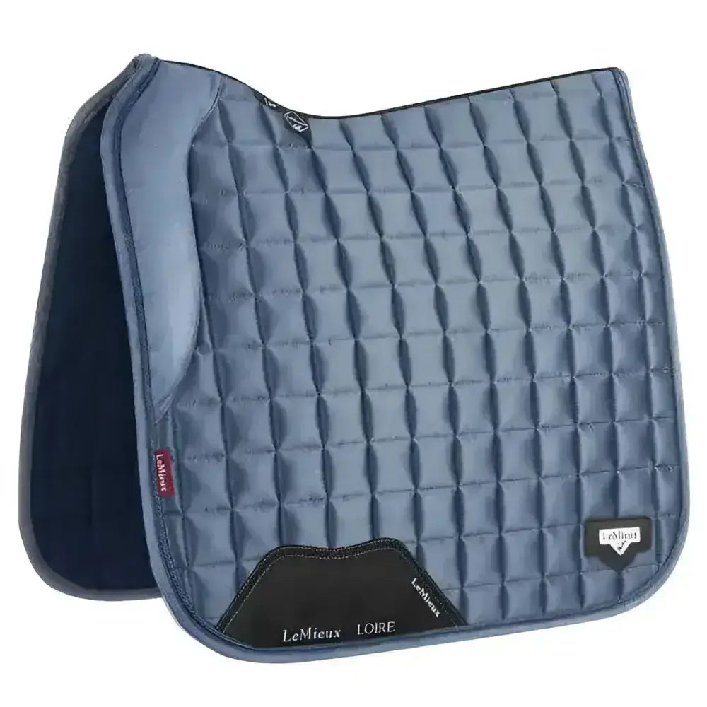 Blue quilted lemieux loire memory dressage square ice saddle pad with black trim in square ice blue color
