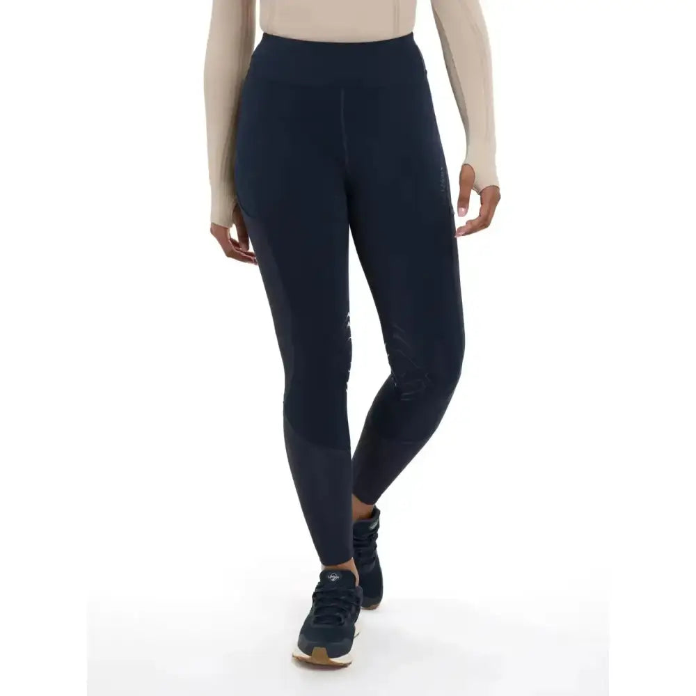 Navy blue high-waisted lydia mesh leggings by lemieux with subtle paneling and a sleek form-fitting design