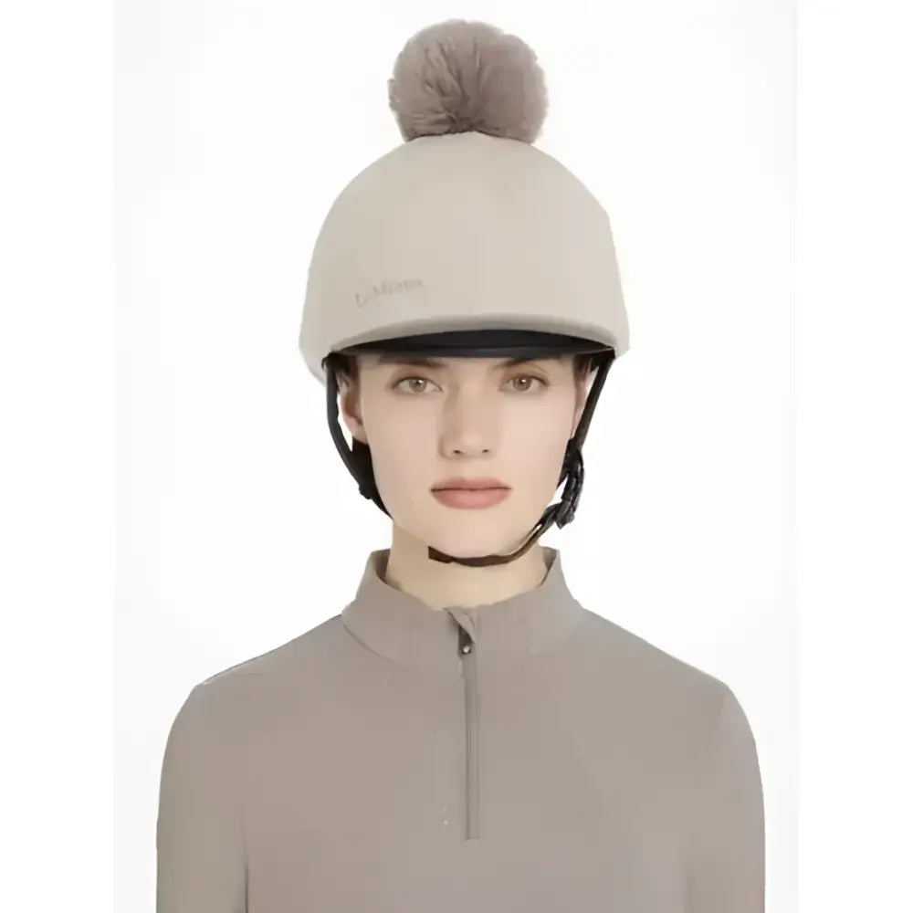 Beige lemieux maria mesh equestrian helmet with soft gray pom-pom top in silk almond color