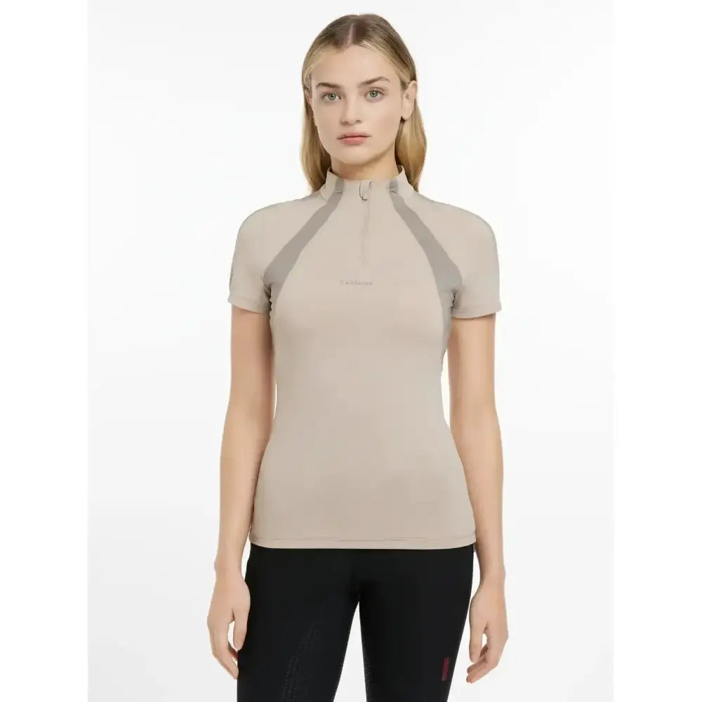 Beige lemieux maria mesh short sleeve baselayer with gray panels and half-zip neckline for athletic wear