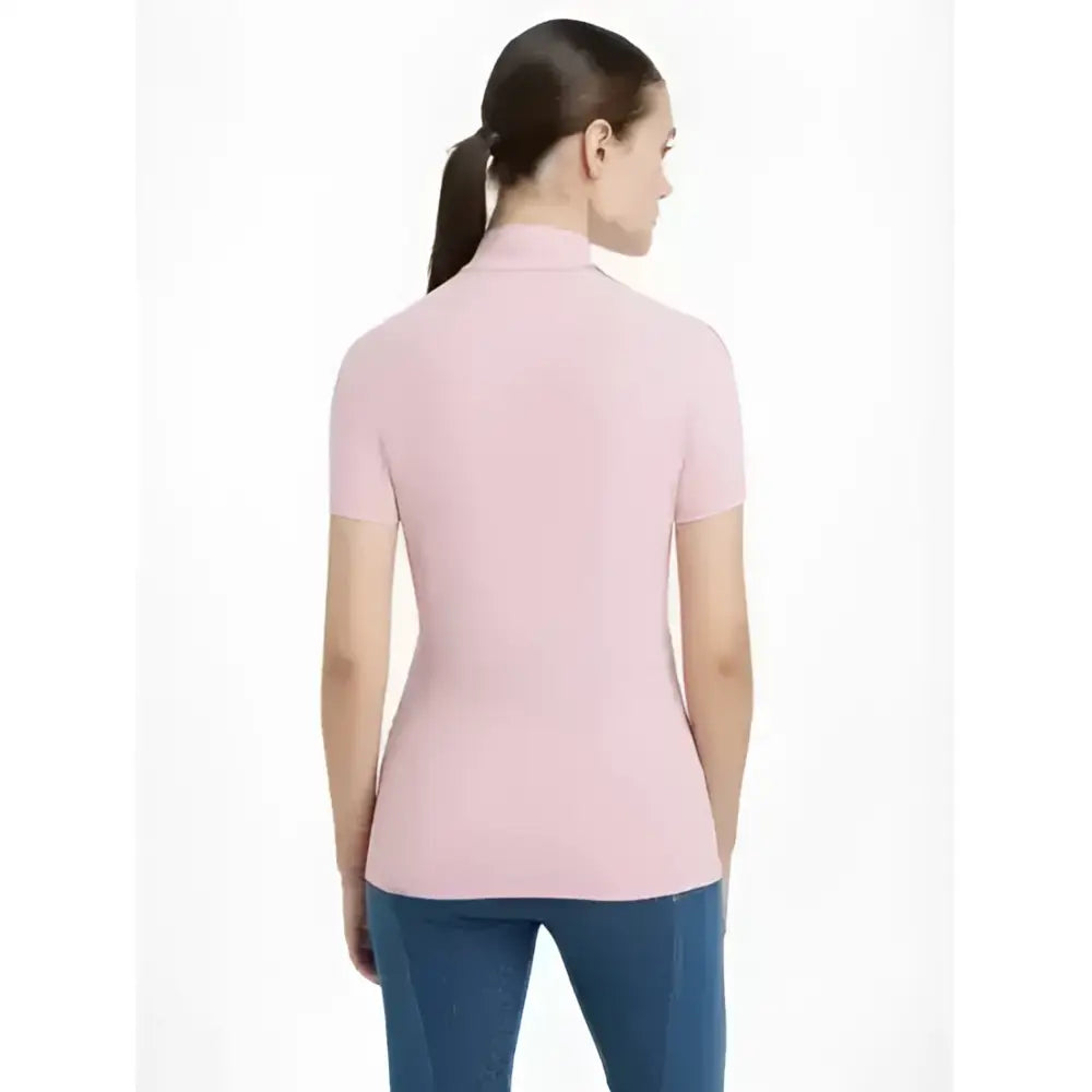 A soft pink lemieux maria mesh short sleeve baselayer blossom top with a smooth knit texture and turtleneck design