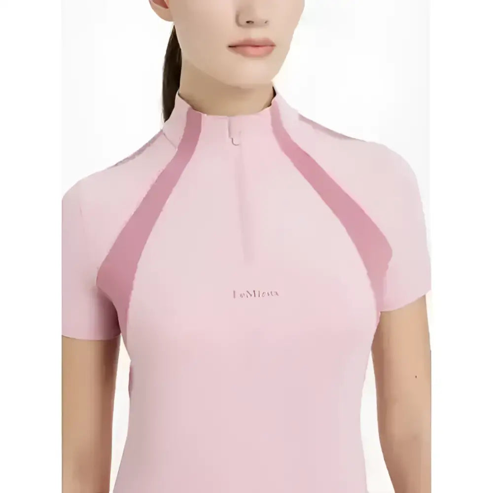A soft pink lemieux maria mesh short sleeve baselayer blossom top with high collar and darker pink shoulder panels
