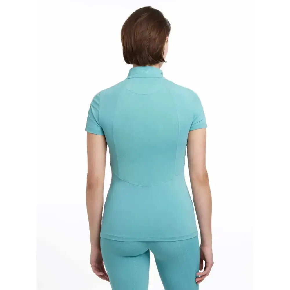 A teal lemieux maria mesh short sleeve baselayer lagoon polo with a high collar and fitted design