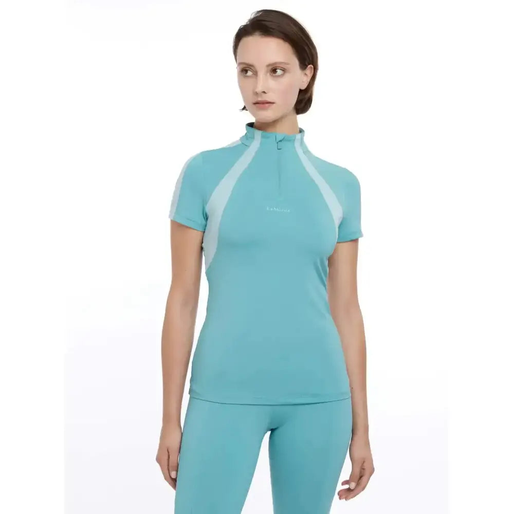 Teal lemieux maria mesh short sleeve baselayer lagoon with light blue panels and a half zip collar