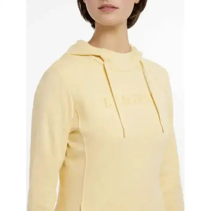 A soft pale yellow lemieux martha hoodie mimosa with long sleeves, subtle chest embroidery, and matching drawstrings