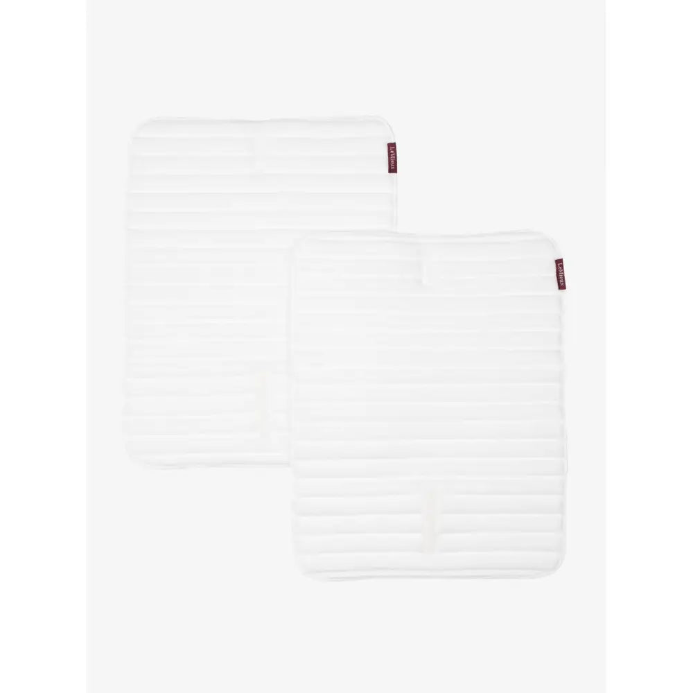 White lemieux memory foam bandage pads with quilted foam material and subtle horizontal stitching and red brand tags