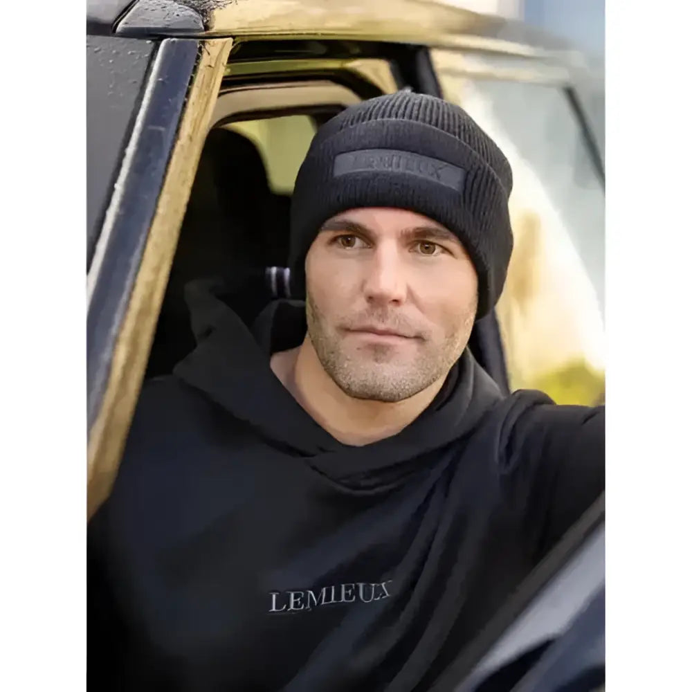 Black knitted lemieux mens beanie with subtle gray logo patch perfect for cold weather style