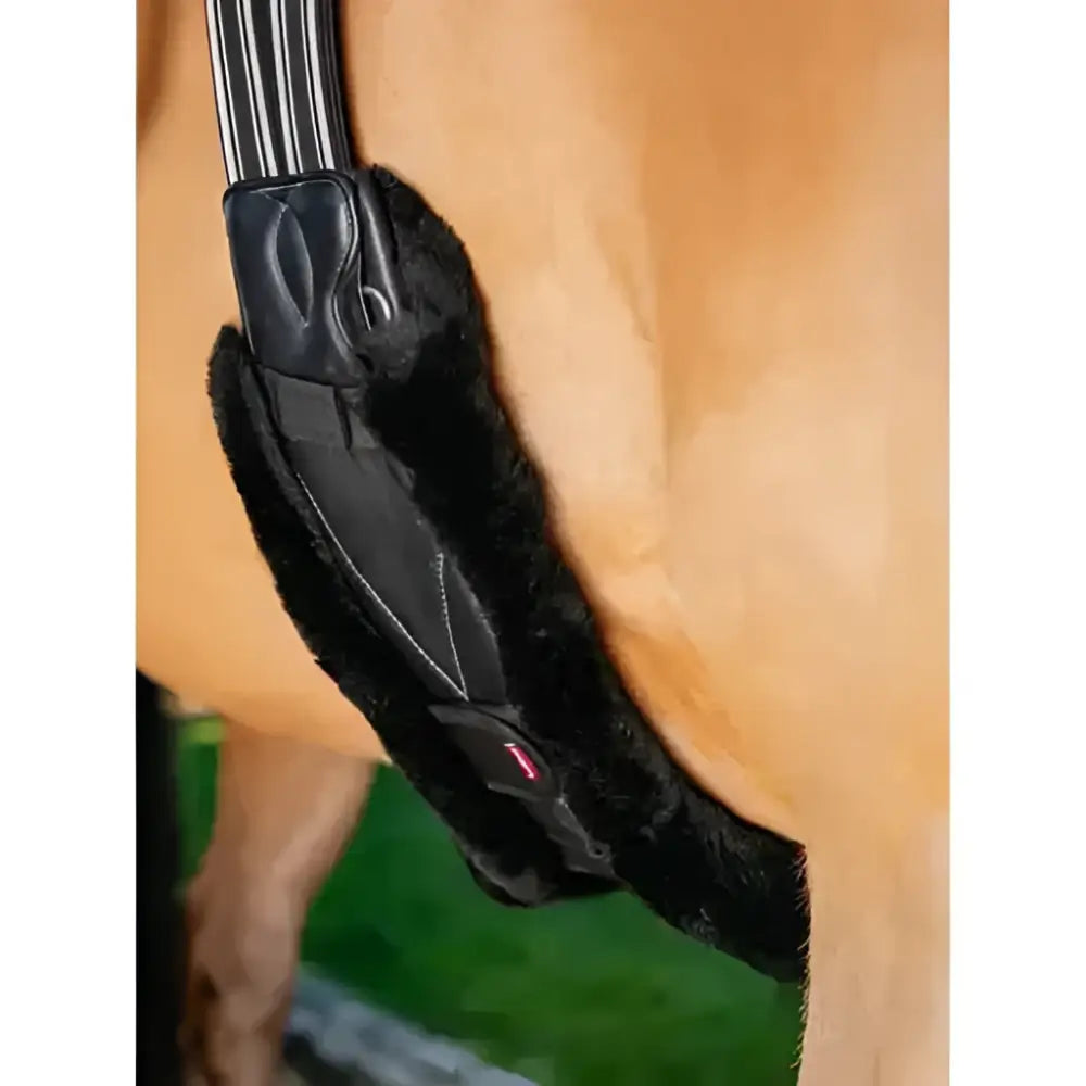Black faux fur LeMieux merino+ anatomic long stud girth cover black with sleek padded design and subtle stitching details
