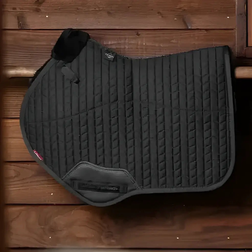 Black quilted LeMieux merino+ half lined close contact square saddle pad with padded flap and reinforced edges