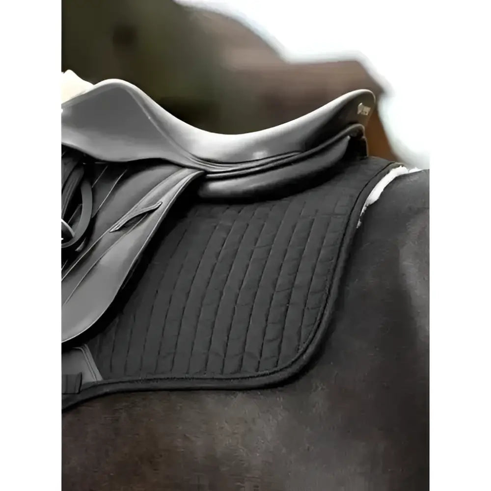 Black quilted saddle pad with ribbed texture under silver saddle in lemieux lined suede eurojump square black