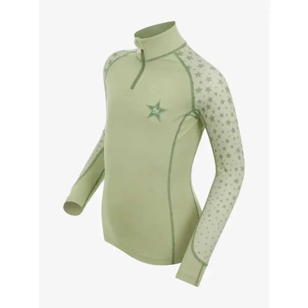 A light sage green lemieux mini base layer fern long-sleeved top with star pattern and quarter-zip collar for mini rider’s running