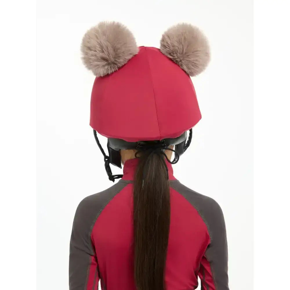 Bright red lemieux mini double pom hat silk ember with two fluffy beige pom-poms on top for equestrian use