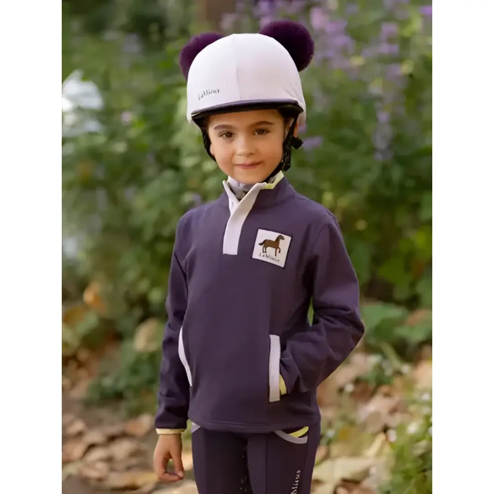 White la sportiva equestrian helmet with purple pom-poms shown with lemieux mini mae popper fleece juniper jacket