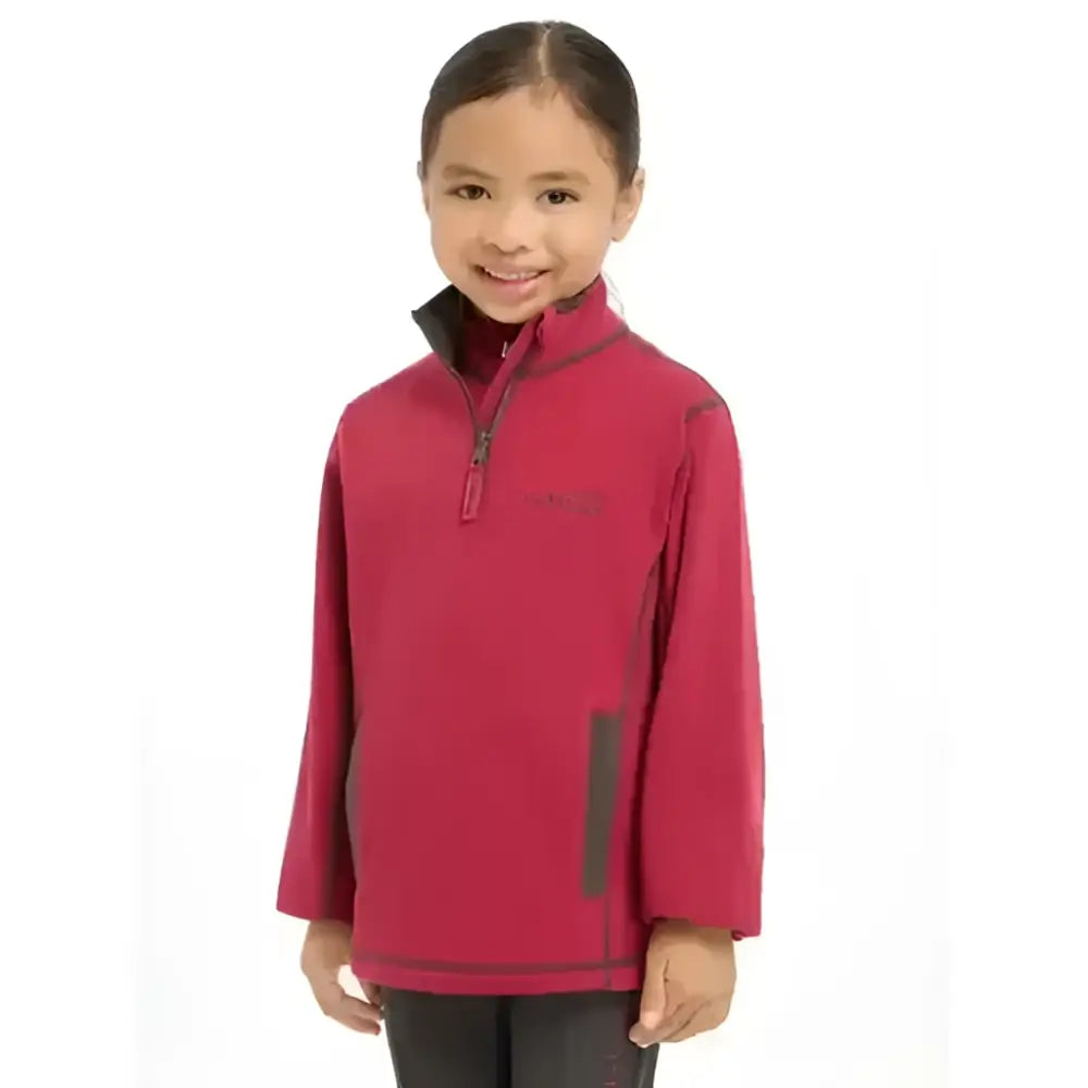 A child wearing a vibrant red lemieux mini mari micro fleece ember jacket with black trim and gray side panels