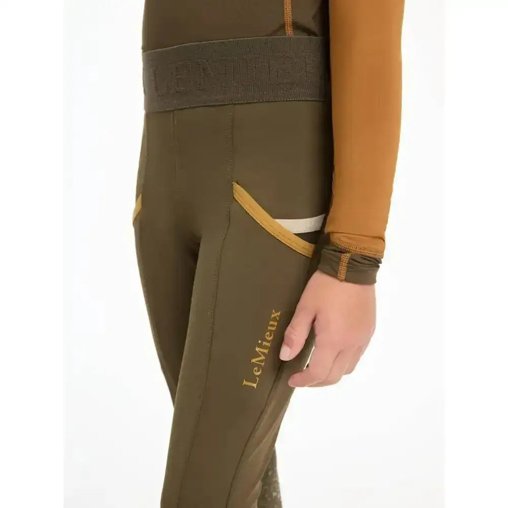 Olive green lemieux mini pull ons alpine leggings with gold trim and embroidered brand name along side seam