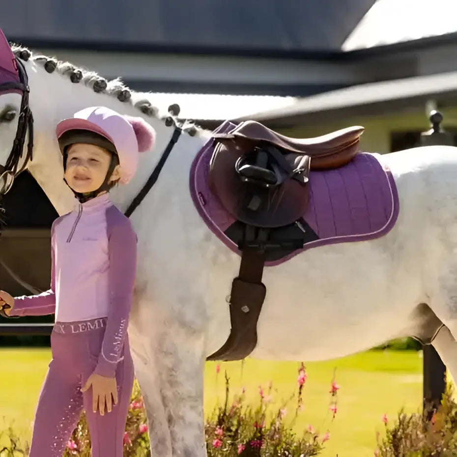 Purple lemieux mini suede equestrian helmet with matching ear flaps and padded interior for close contact riding