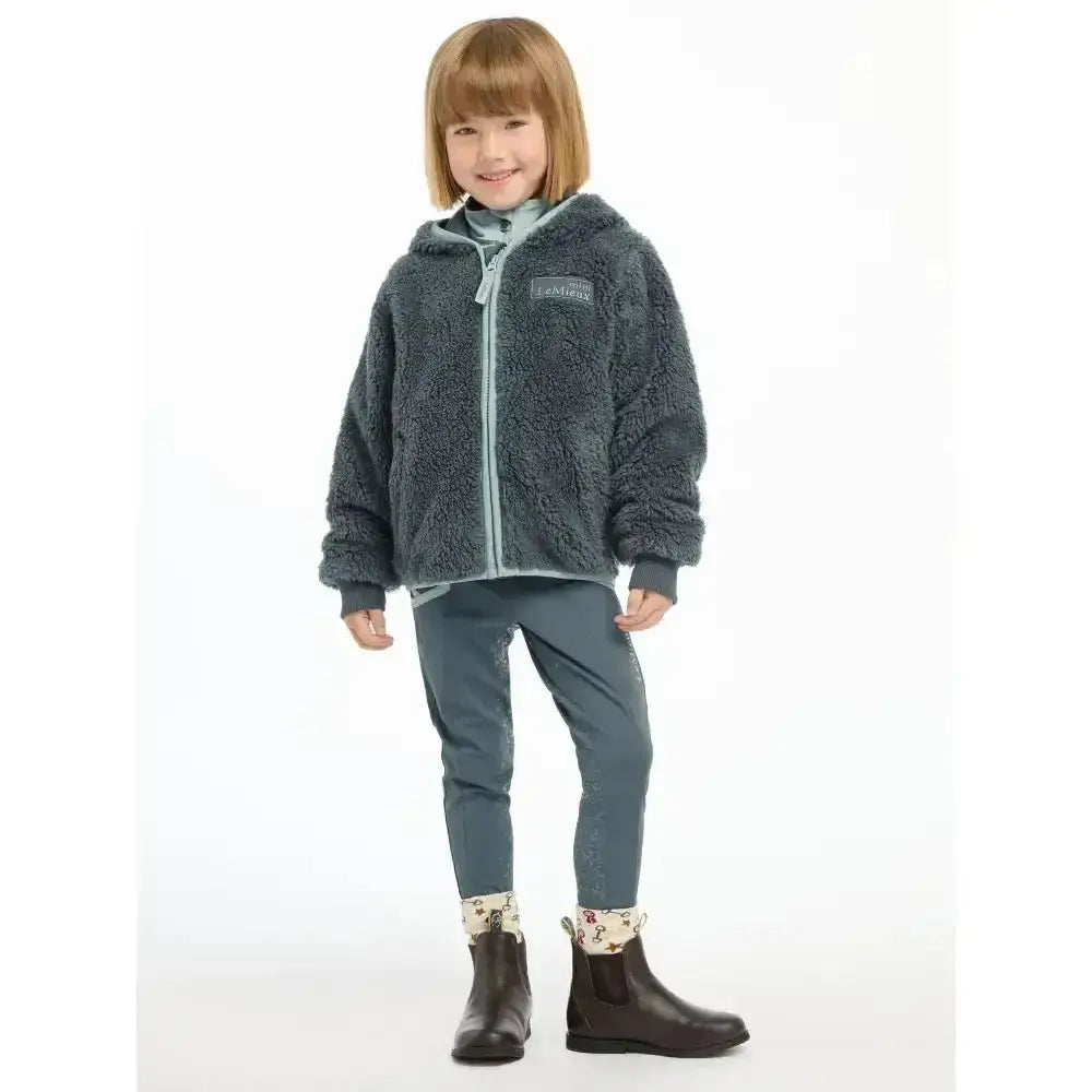 Dark gray fluffy hooded lemieux mini teagan fleece petrol jacket with light blue zipper and chest brand patch