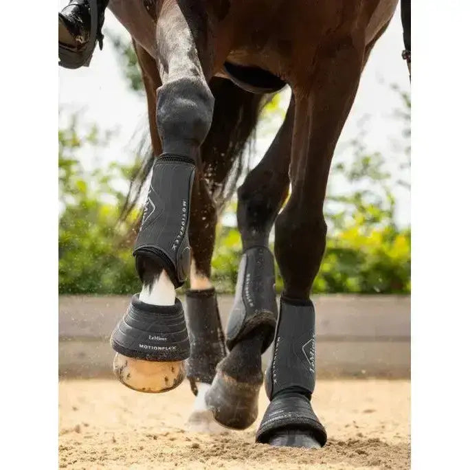 Black lemieux motionflex dressage boot with sleek flexible design and subtle white branding for protection and support