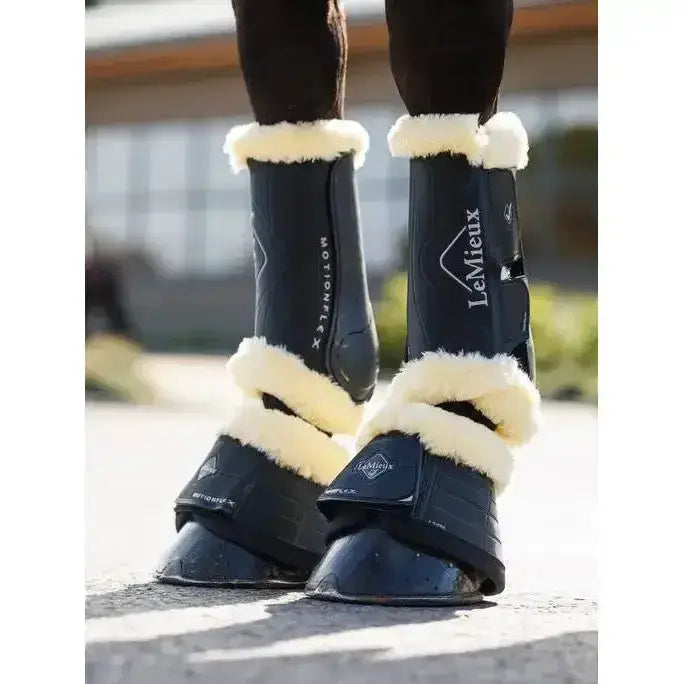 Black lemieux motionflex reach boots with cream fleece edge black lining and sleek protective design for horses