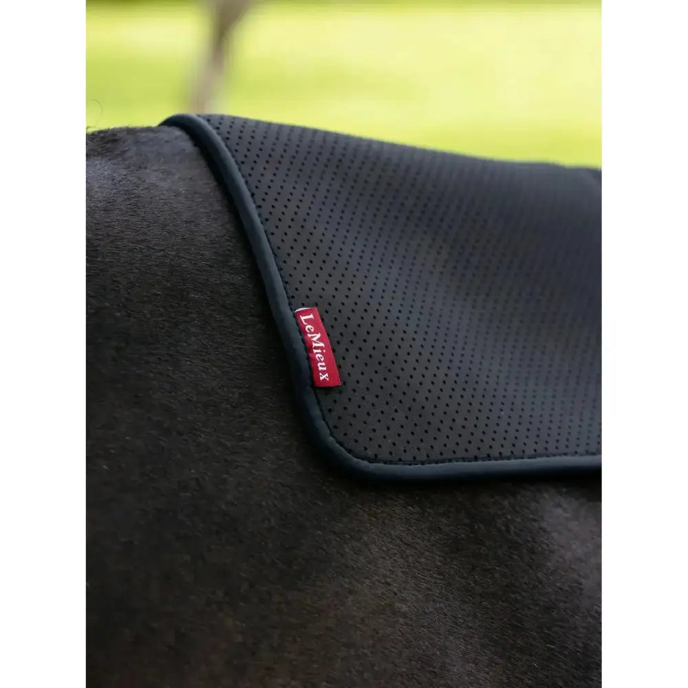 Black perforated lemiueux half pad square black with red tecmieux brand tag for non slip saddle support