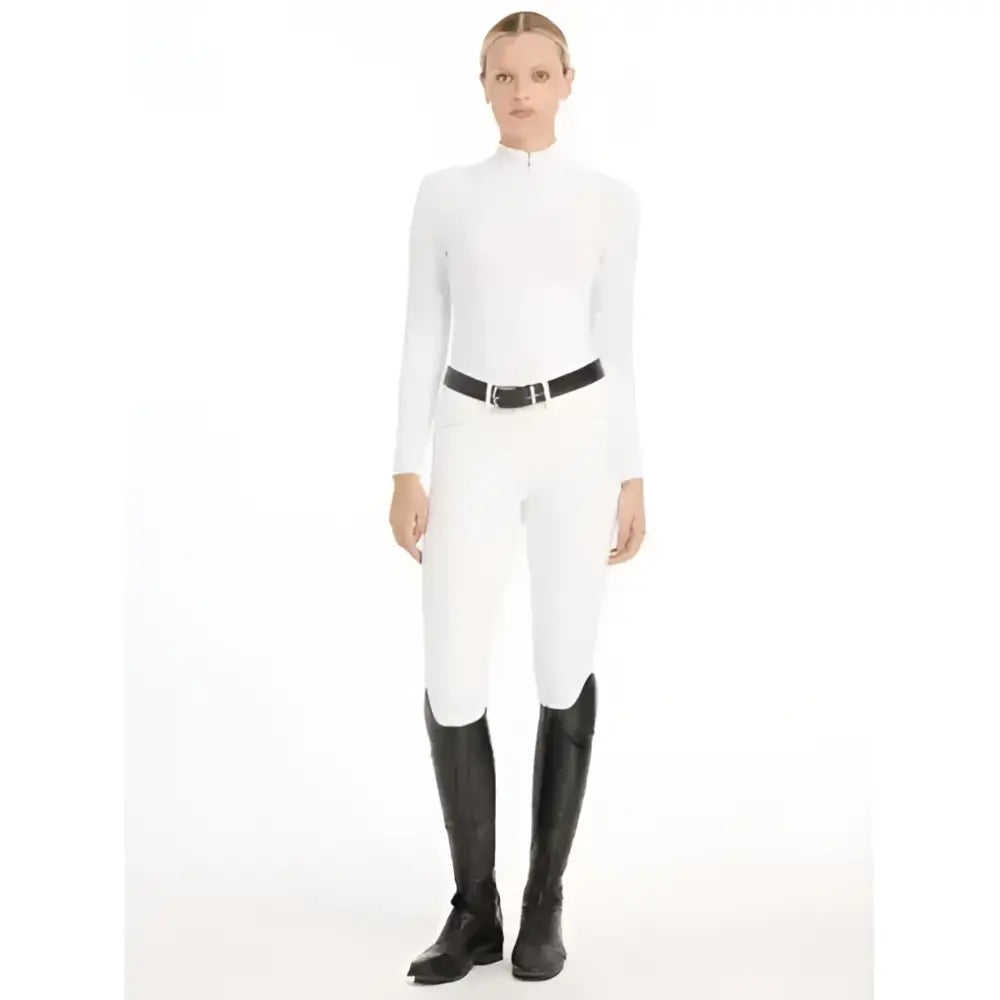 White high waist riding pants with a sleek fit paired with lemieux olivia long sleeve laser-cut lace shirt