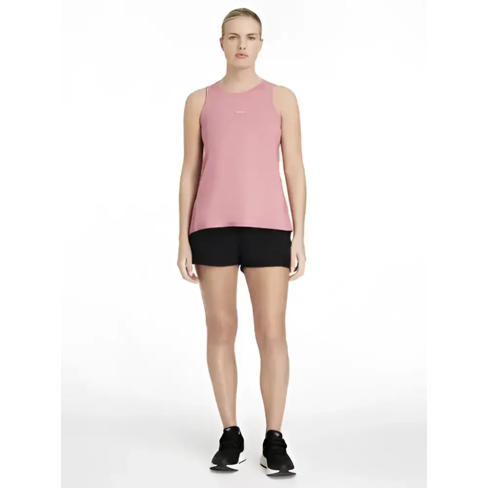 A soft pink sleeveless athletic top with subtle logo paired with lemieux penny shorts black for shorts layer look