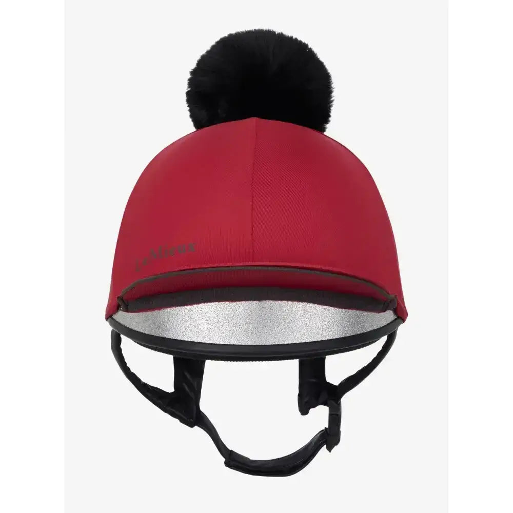 Red lemieux pippa hat silk ember with a black faux fur pom-pom and silver reflective trim for equestrian use