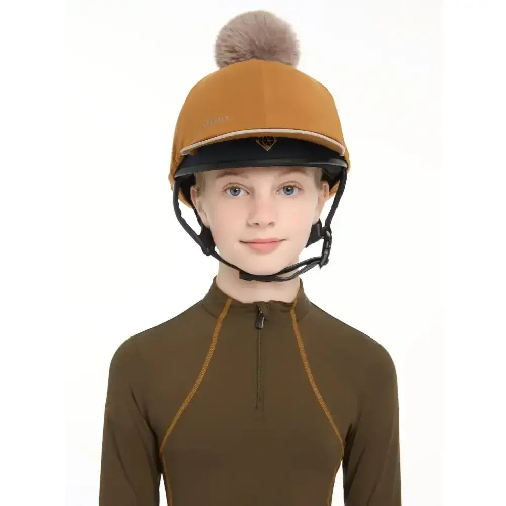 Tan lemieux pippa hat silk ginger equestrian helmet with black brim and fluffy brown pom-pom on top