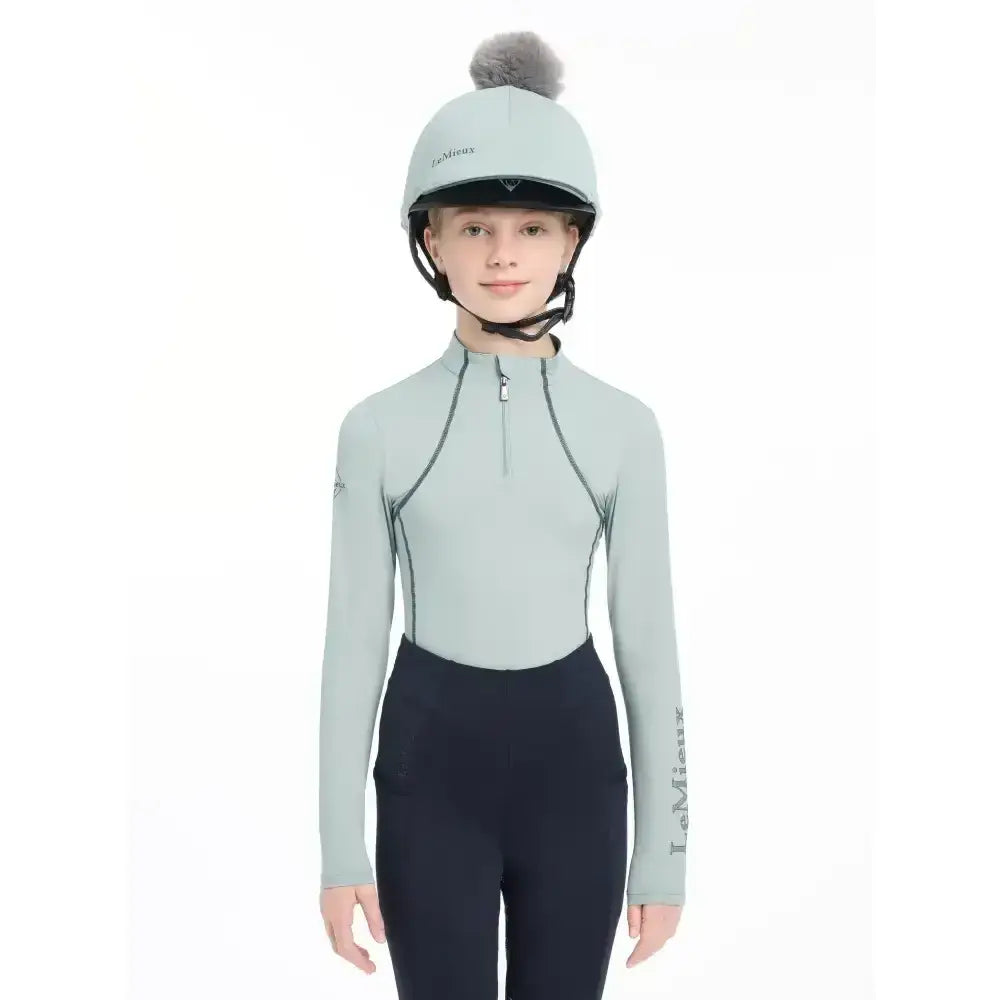 Light green lemieux pippa hat silk long-sleeved equestrian top with black zipper and silky smooth four-way fabric