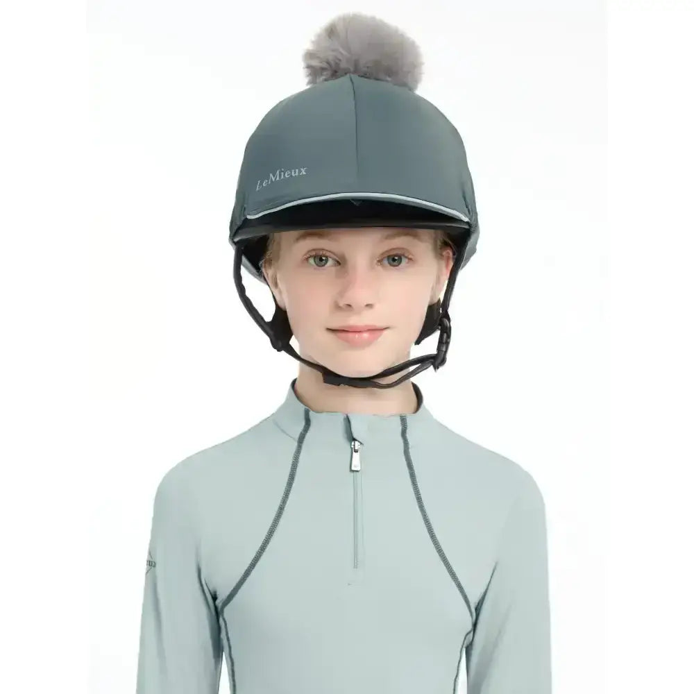Gray lemieux pippa hat silk petrol with fluffy pom-pom and silky smooth four-way fabric for equestrian use