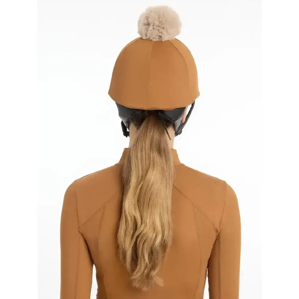 Tan lemieux pom hat equestrian helmet with fluffy beige pom pom made from silky smooth four way hat silk ginger fabric