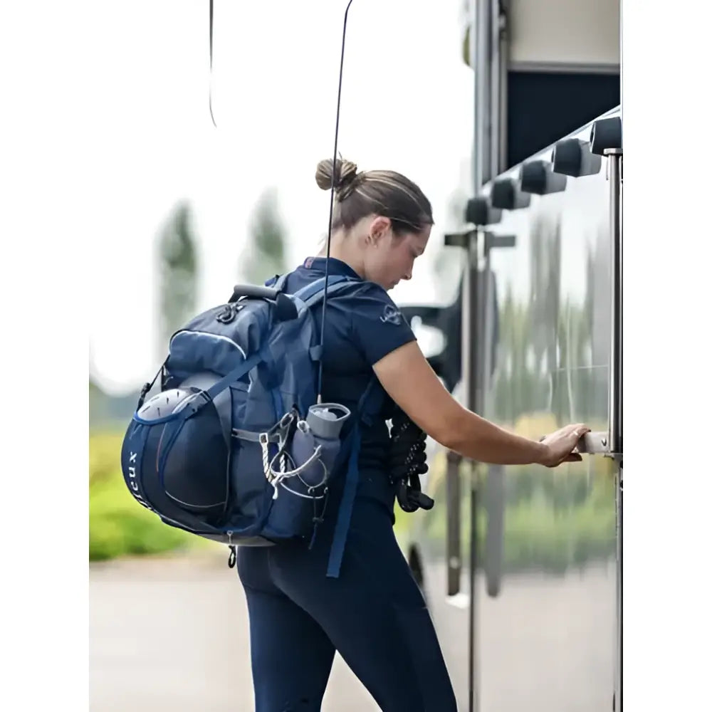 Navy blue lemieux pro rucksack with multiple compartments and water bottle holders perfect for a tuck-away riding hat