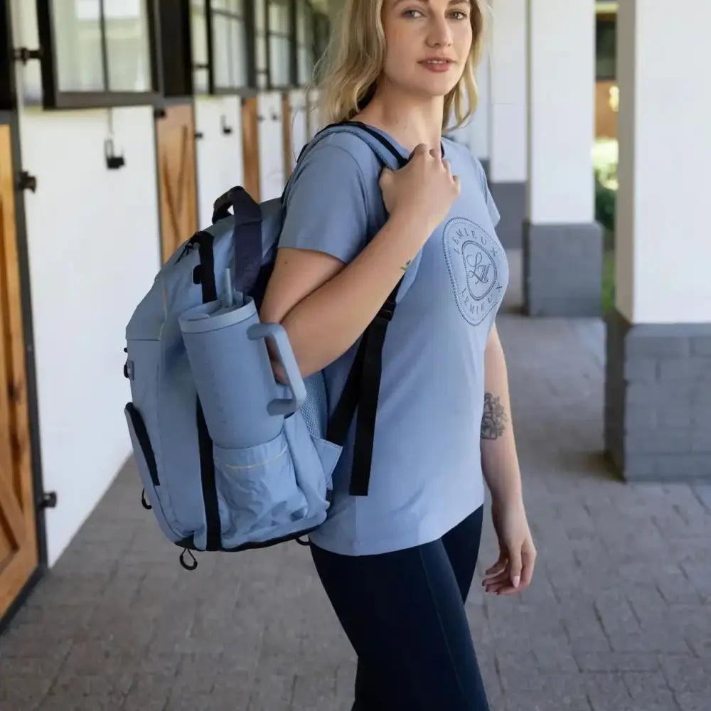 Light blue lemieux pro rucksack with black straps and side hat holder perfect for everyday use