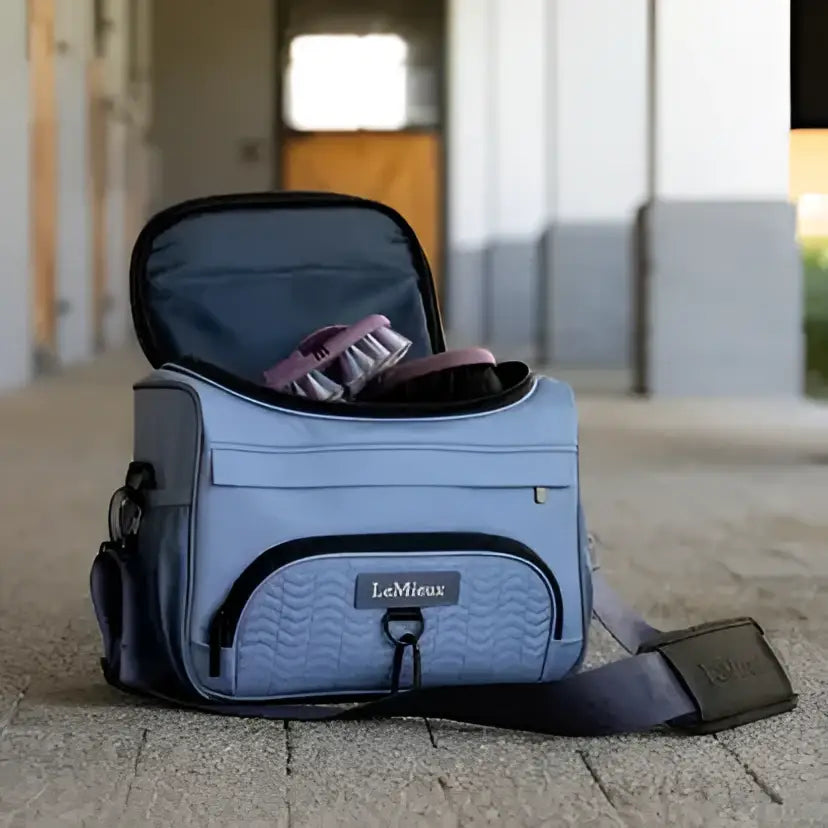 Light blue lemieux prokit lite grooming bag with quilted front panel and black trim in powder blue grooming style