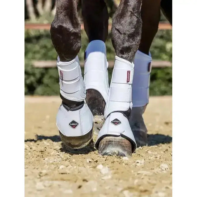 White proshell brushing boots with black accents and diamond lemieux logo for horse leg protection