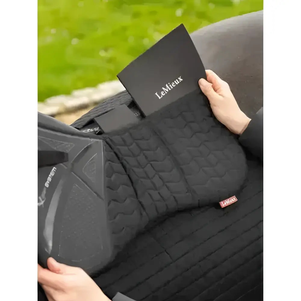 Black lemieux prosorb plain pocket quilted half pad with textured padding and red lemieux tag perfect for riding