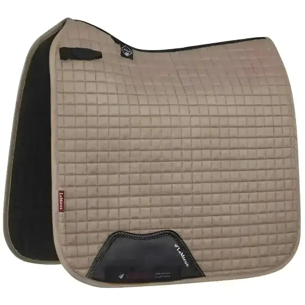 Tan quilted lemieux prosport suede dressage square mink saddle pad with black trim and branded logo patch