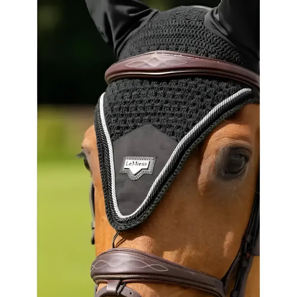 Black knitted puissance fly hood with brown leather trim silver stitching lemieux patch protects horse’s ears with handy elastic tie