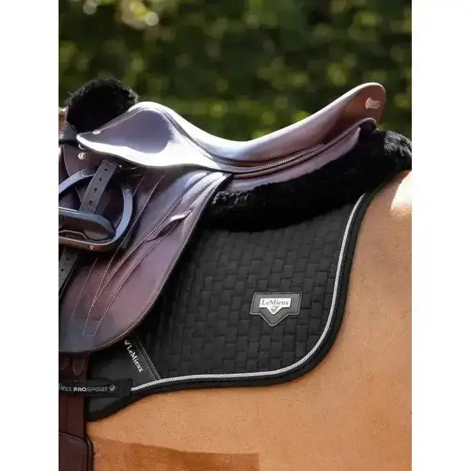 Black woven lemieux puissance suede close contact square saddle pad with silver stitching and lemieux logo patch