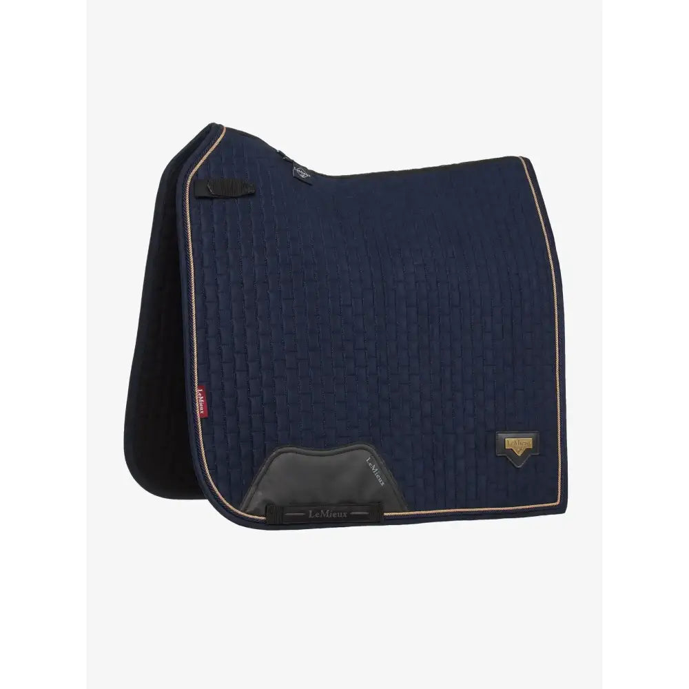 Navy blue lemieux puissance suede dressage pad with black trim and gold branding in quilted suede material