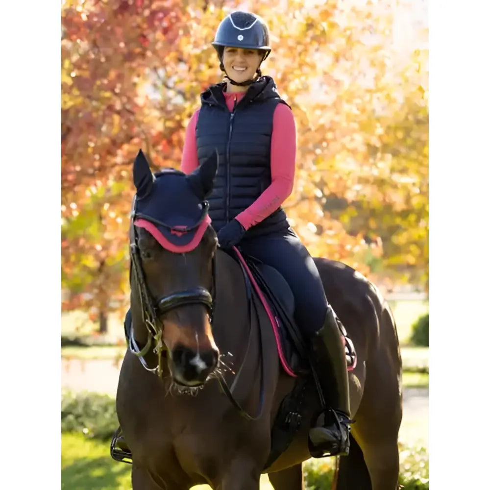 Black and pink padded horse headgear paired with lemieux rose hooded puffer navy hooded puffer gilet detail