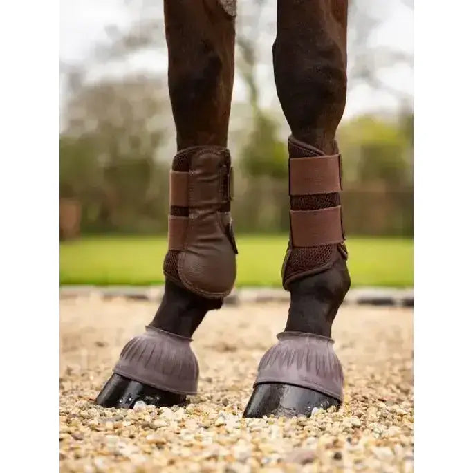 Brown leather lemieux rubber pull conventional overreach boots with adjustable straps and protective padded flaps